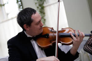 Alex Postlethwaite playing his violin